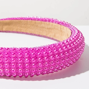 Close-up of pink baroque headband featuring dense artificial pearls on thick sponge