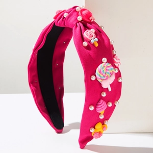 Cerchietto annodato rosa fucsia con perle bianche e ciondoli colorati a forma di caramella