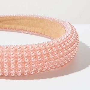 Macro detail of high-quality pink imitation pearls on a vintage sponge headband