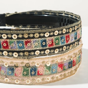 Detailed macro view of bohemian embroidery headband with colorful sequins and anti-slip teeth