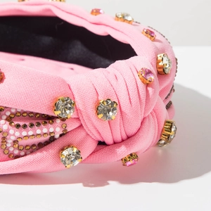 Detail of pink knotted bridal headband with large crystals and fine rhinestone setting