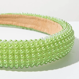 Detail of light green pearl hair hoop featuring tiered faux pearls and non-slip lining