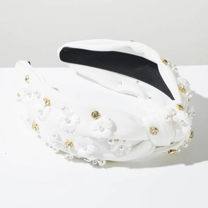 Detailed view of white fabric headband with delicate pearls, floral motifs and crystals