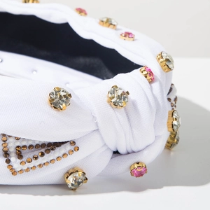 Detailed macro view of white fabric headband with rhinestones and bead decorations