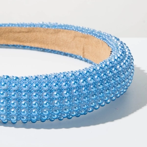 Detail of light blue sponge headband with layered glossy pearls and suede lining