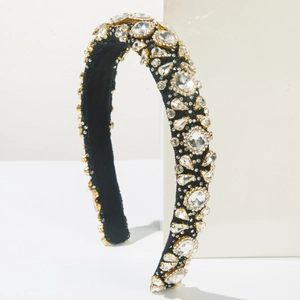 Luxury Baroque headband with colorful crystals and gold trim on a minimalist white stand