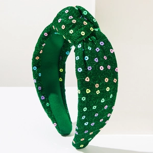 Close-up of green sequin headband with knotted design and colorful sparkling floral details