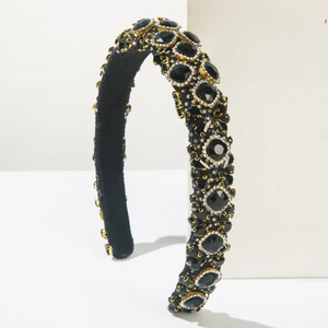 Macro shot of luxury velvet headband featuring intricate black rhinestones and gold details