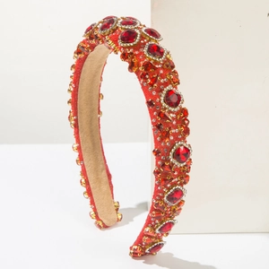 Close-up of luxury padded headband with sparkling red crystals and ruby waterdrop gems