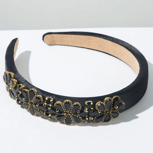 Detailansicht eines schwarzen Satin-Haarreifs mit goldenen Blumen und Kristallen