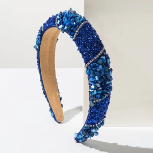Macro detail of blue headband with crushed stone textures and parallel rhinestone bands