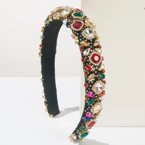 Close-up of luxury Baroque headband featuring multi-colored rhinestones in gold claw settings