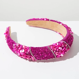 Detail of rose red padded headband with pink stones and sparkling rhinestones