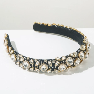 Macro shot of detailed baroque headband with crystal rhinestones on a black velvet base