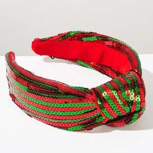 Detail of red and green sequin knotted headband with festive Christmas snowflake pattern