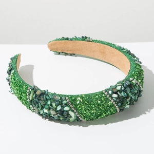 Close-up of handmade green headband featuring mixed rhinestones and crushed stones