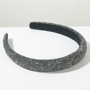 Detailed view of the sparkling silver rhinestone padded headband with soft black inner lining