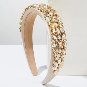 Detail of luxury baroque headband with champagne crystals and white pearls on satin