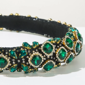 Close-up of green crystal baroque headband with pearl embroidery and silver accents
