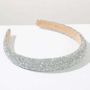 Detailed macro view of sparkling silver rhinestone headband with soft beige velvet lining
