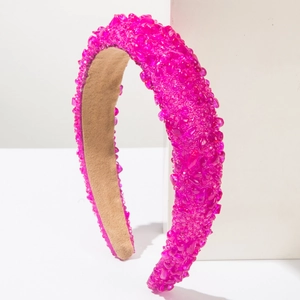 Detailed close-up of vibrant pink crystal beads on a wide baroque sponge headband for women
