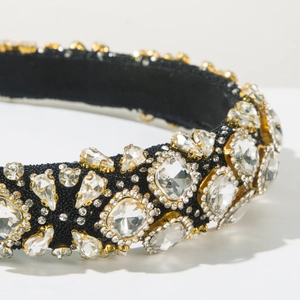 Close-up of sparkling crystals in gold claw settings on a luxury Baroque headband