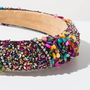 Macro shot of fashion headband featuring colorful crushed stones and sparkling rhinestones