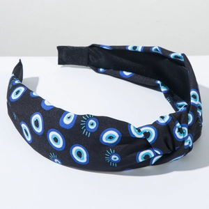 Detail view of the black fabric knot headband featuring blue Evil Eye printed patterns