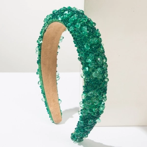Detail of dark green beaded headband with crystals and soft brown suede lining
