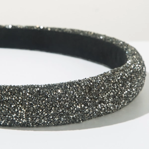 Close-up detail of luxury sponge headband with dense dark grey crystal rhinestones