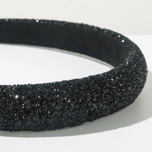 Close-up detail of luxury black headband with high-density sparkling crystals for parties