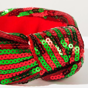 Close-up of red and green sequined Christmas headband featuring a twist knot detail