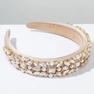 Detailed close-up of champagne satin headband with baroque crystal and pearl embroidery