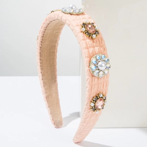 Detail of pink padded headband with inlaid pearls and floral crystal ornaments