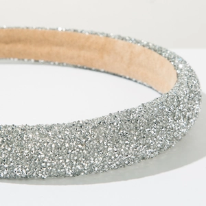 Close-up of sparkling silver crystals on a luxury padded headband for parties
