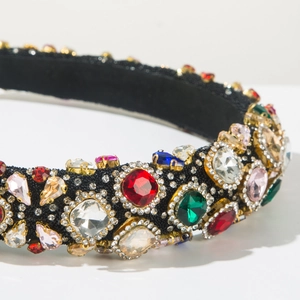 Detail of baroque headband with large colorful crystals and diamonds on black velvet