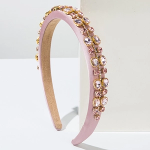Pink satin headband with sparkling rhinestones and gold metal claw settings