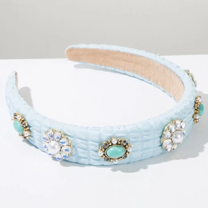 Detail view of light blue fabric headband with turquoise stones, pearls and rhinestones