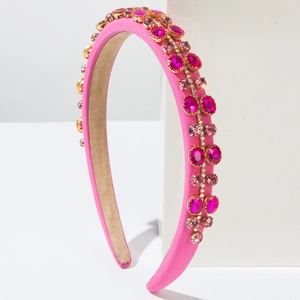 Detail of pink padded headband with handcrafted crystals and golden claw settings