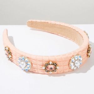 Detail of pink quilted headband featuring cluster of faux pearls and colored rhinestones