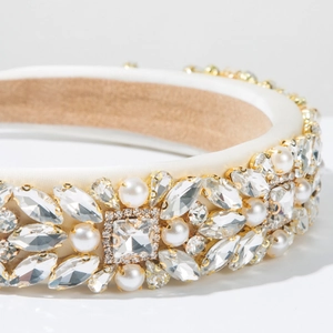 Macro detail of luxury beige satin headband with intricate rhinestone and pearl embroidery