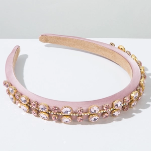 Detail of padded velvet headband with pink gemstones and gold metal base