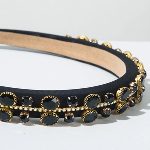 Macro detail of luxury padded headband with black gems and colorful rhinestones