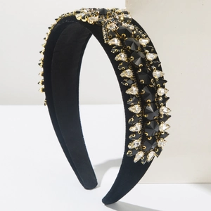 Close-up of luxury Baroque headband with black velvet and sparkling crystals in gold claw settings