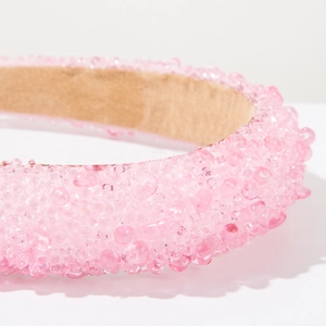 Detail shot of the pink crystal beaded surface and khaki anti-slip fabric lining on the headband