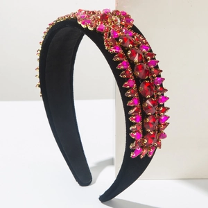 Detailed view of luxury baroque headband with red crystals on black velvet base