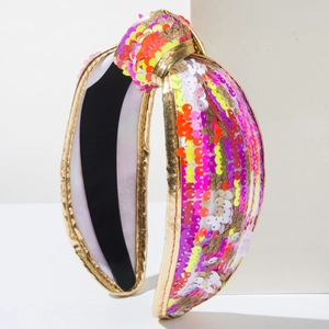 Detail of colorful sequins and gold trim on a wide knotted headband for party wear