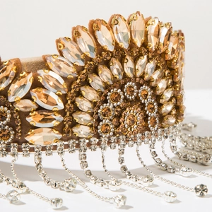 Macro detail of Baroque crown headband with champagne rhinestones and sparkling silver tassels