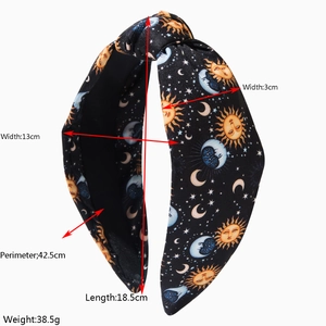 Retro knotted headband with celestial sun and moon prints in a wide fabric design
