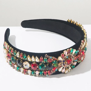 Macro shot of Baroque wide headband with colorful rhinestones on black velvet